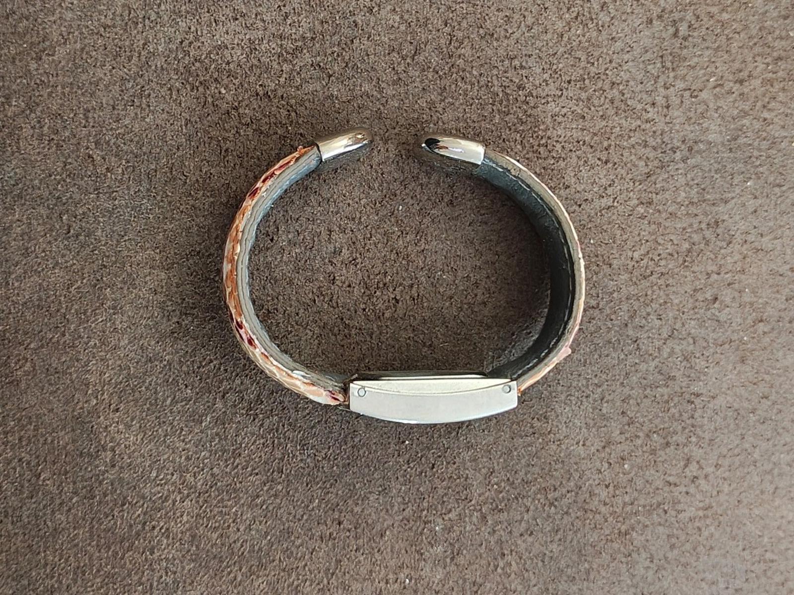Cuff watch bracelet with silver clasp and patterned pink leather strap, side view