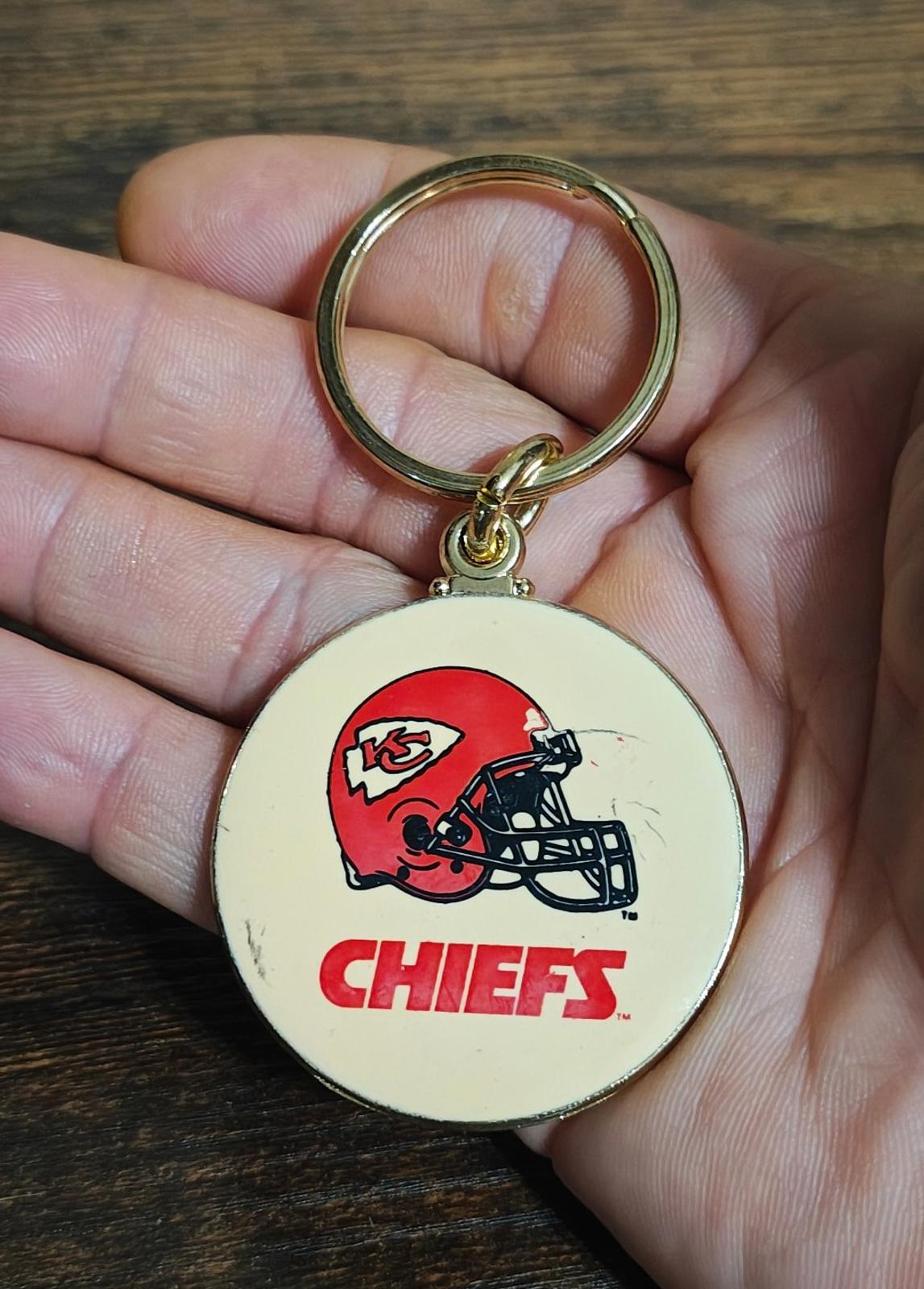 Kansas City Chiefs helmet keychain with gold ring and round white enamel logo face