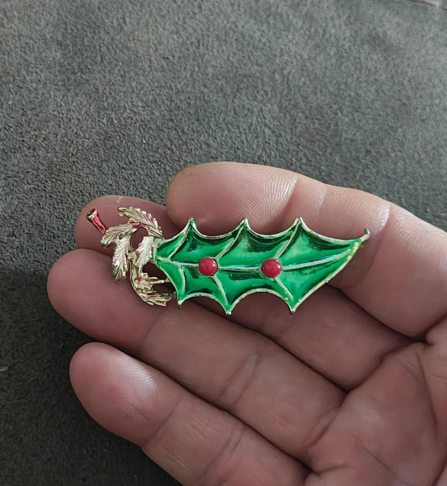Green holly leaf enamel brooch with gold tone detailing and two red berry beads.