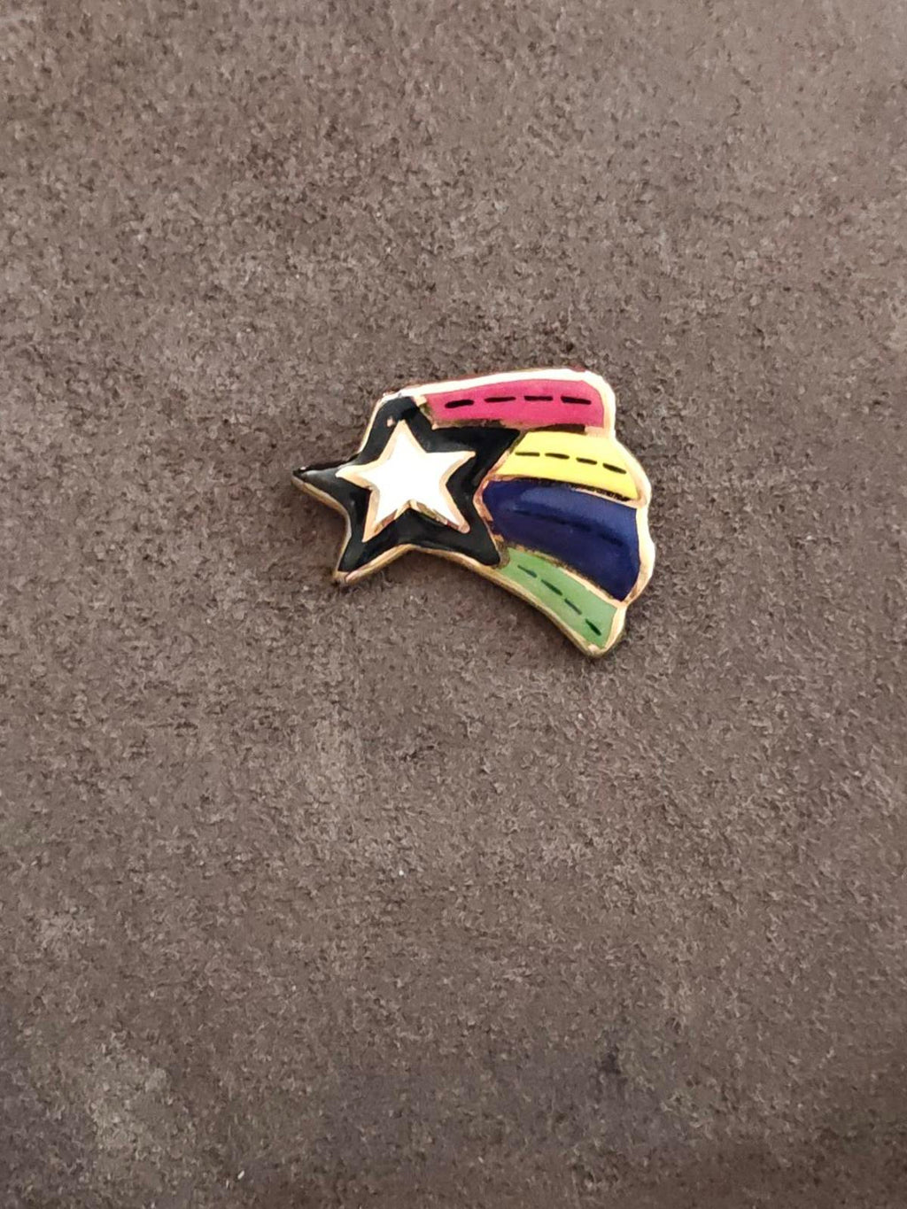Glazed ceramic shooting star pin brooch with rainbow bands and white star center
