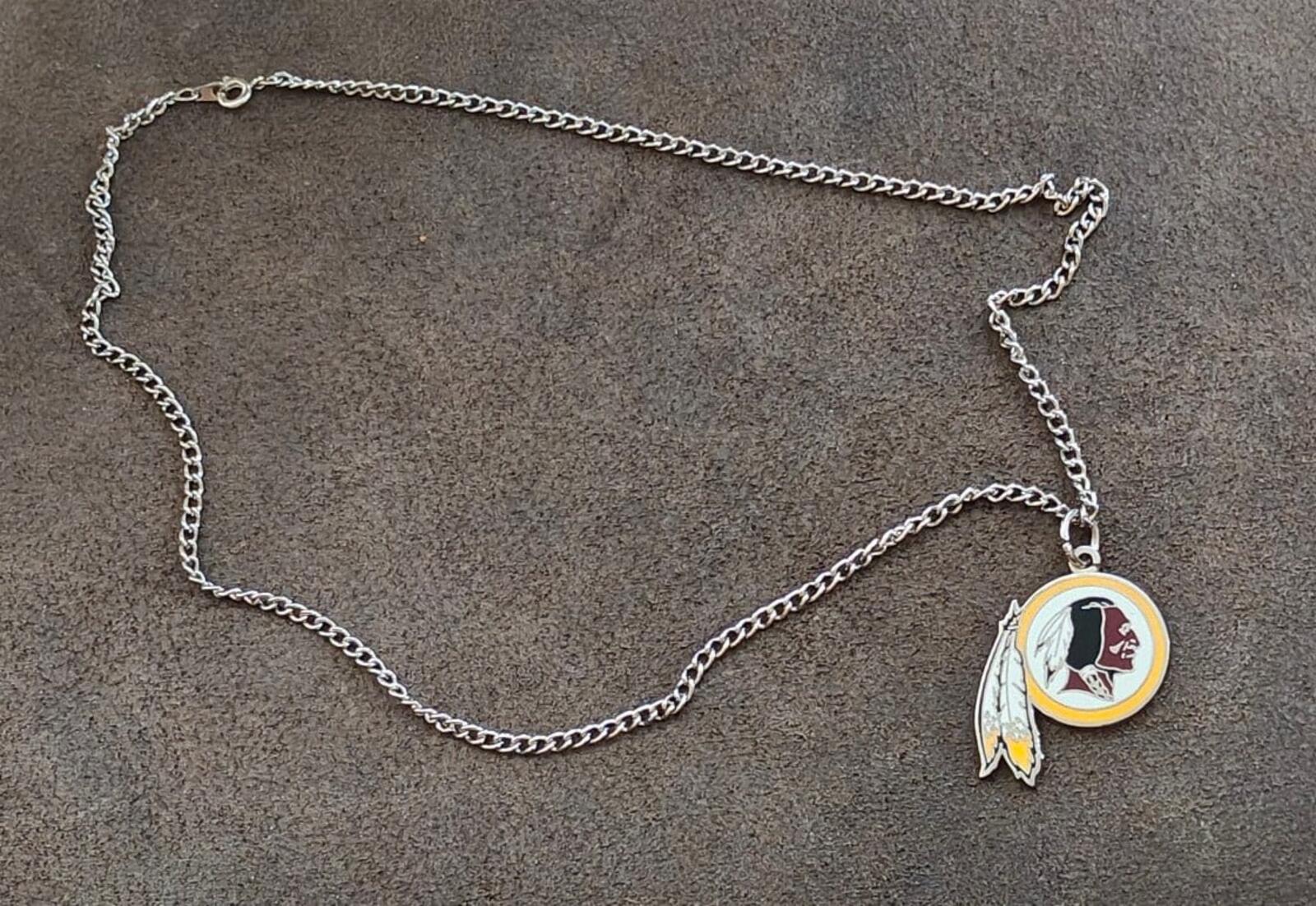Silver chain necklace with round team logo pendant and feather charm