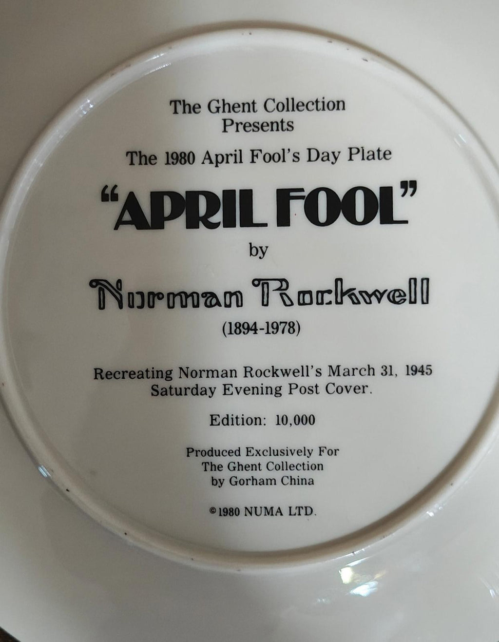 Porcelain plate back close-up: 'APRIL FOOL' title and production details