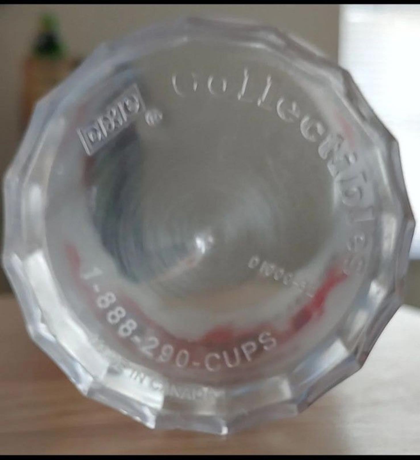 Clear octagonal base of plastic tumbler with embossed text and cup measurement markings