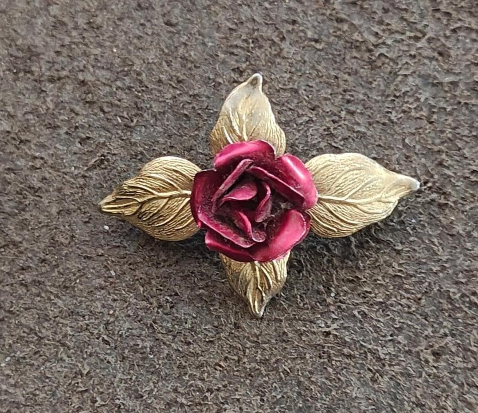 Gold-tone rose enamel brooch with red flower center and raised leaf design