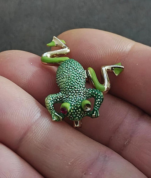 Green frog enamel brooch with gold-tone frame, textured body, and red jeweled eyes