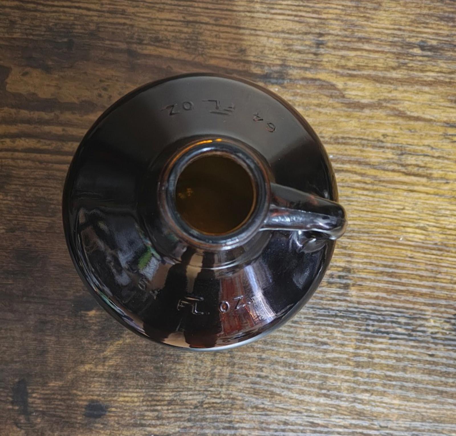 Amber glass jug base with recessed center and embossed markings