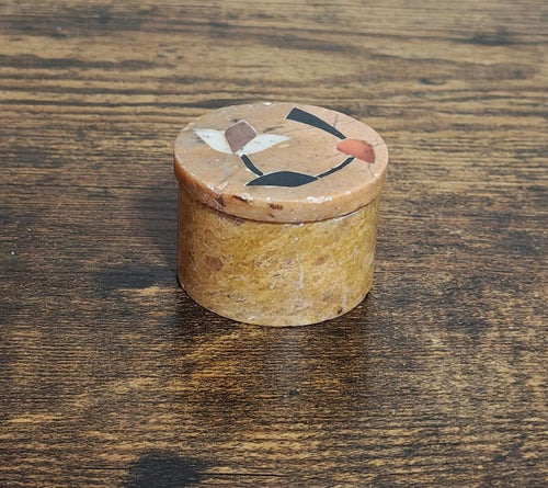 Small round soapstone trinket box with carved floral lid design in beige and dark blue