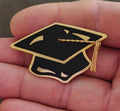 Gold-tone graduation cap brooch with black enamel center and gold tassel