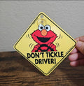 Yellow Elmo car window sign with suction cup; “DON’T TICKLE DRIVER!” graphic