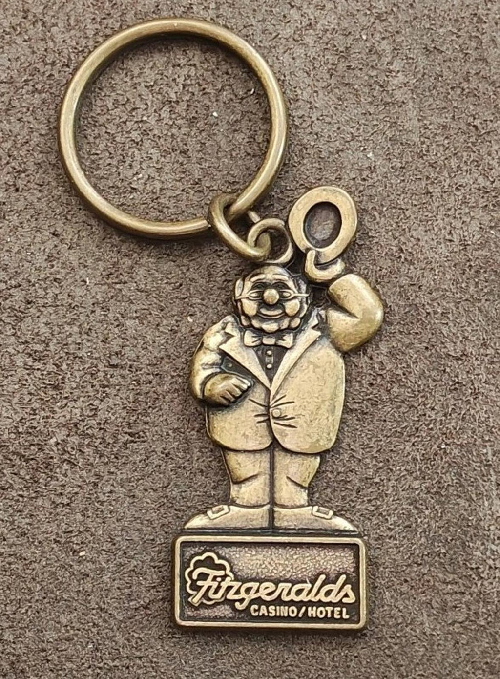 Gold keychain ring with Mr. O’Lucky figure holding up fist; Fitzgerald’s Casino Hotel tag