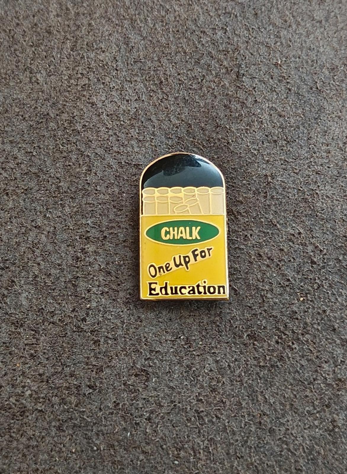 Gold-tone enamel teacher pin from side, chalkboard “CHALK” and “One Up For Education”