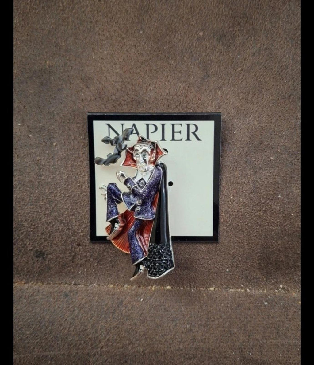 Vampire enamel pin on backing card, dark cloak with red and blue details