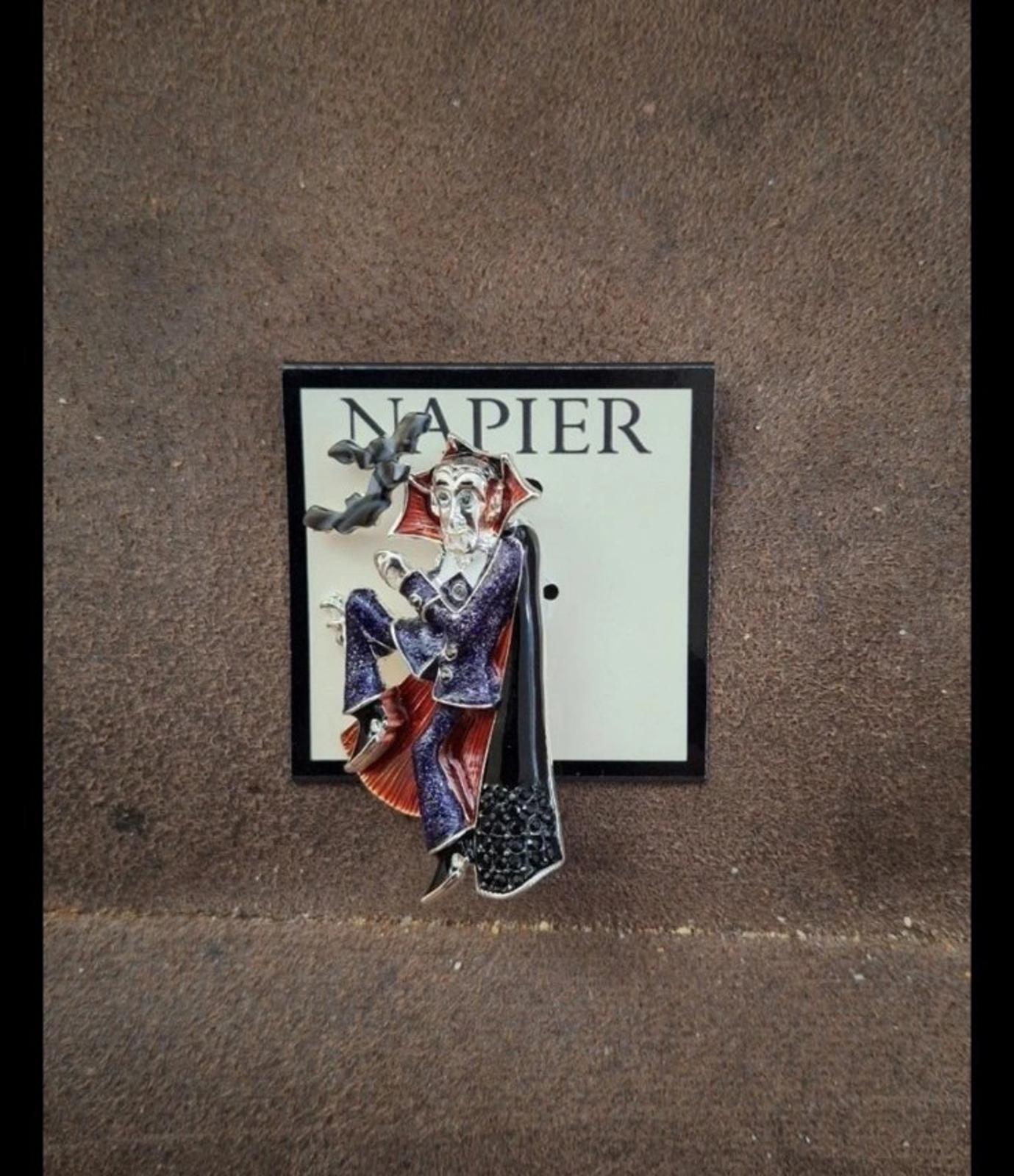 Vampire enamel pin on backing card, dark cloak with red and blue details