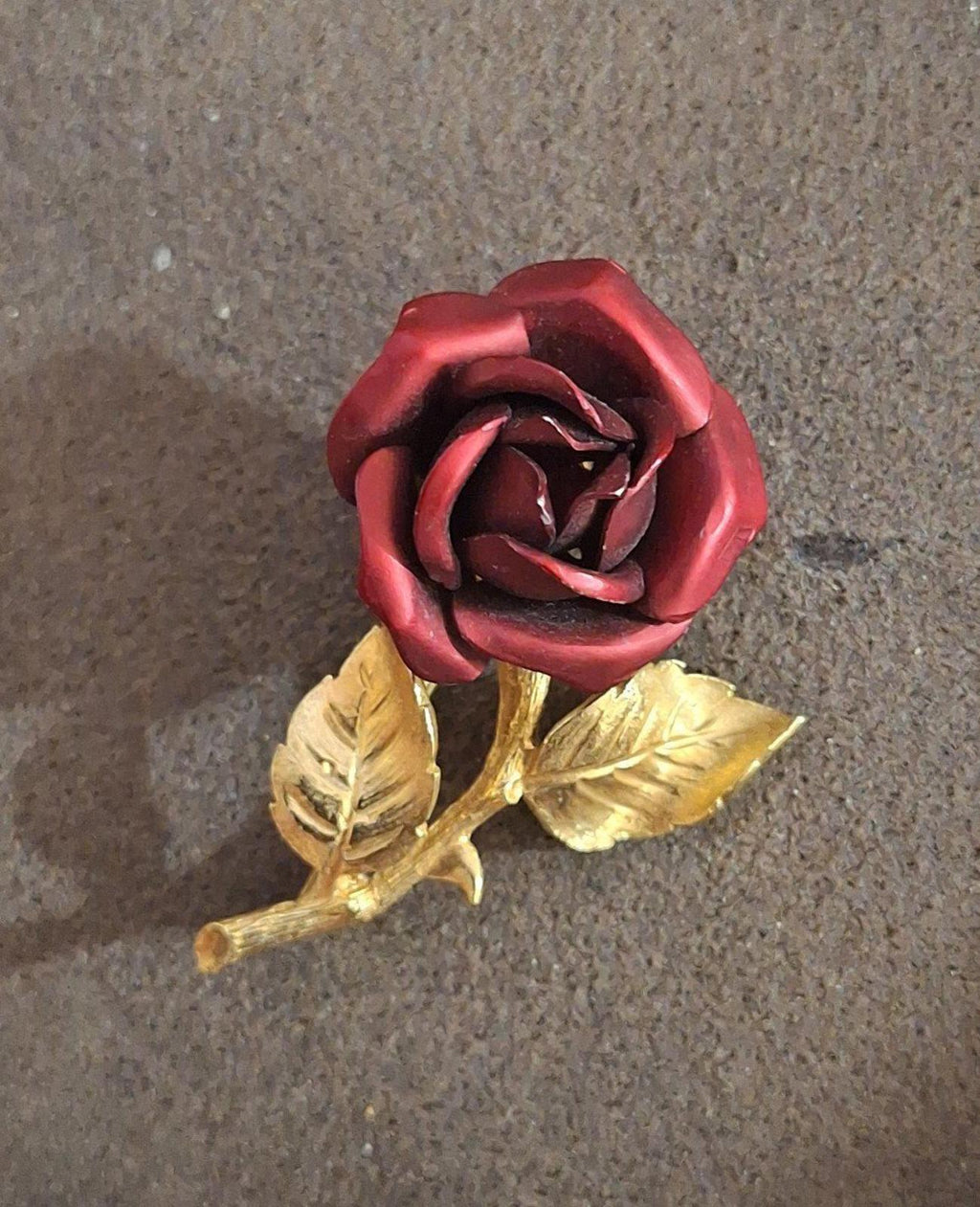 Gold-tone red rose enamel pin with gold leaf accents, centered front view.