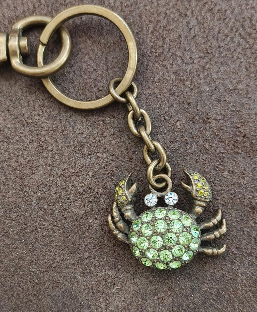 Green crystal crab keychain charm with bronze chain and split key ring.