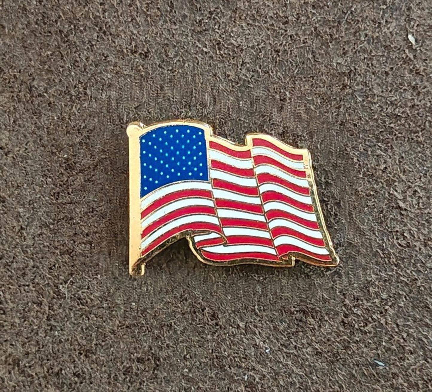 1980s Patriotic Gold Tone Enameled American Wavy Flag Pin.