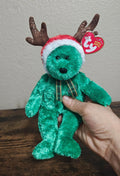Green plush reindeer teddy bear with antlers, plaid scarf, and TY hang tag