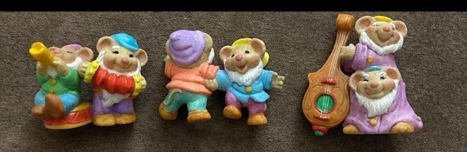 Three-piece dwarf figurine set with left, center, and right figures in colorful clothes.