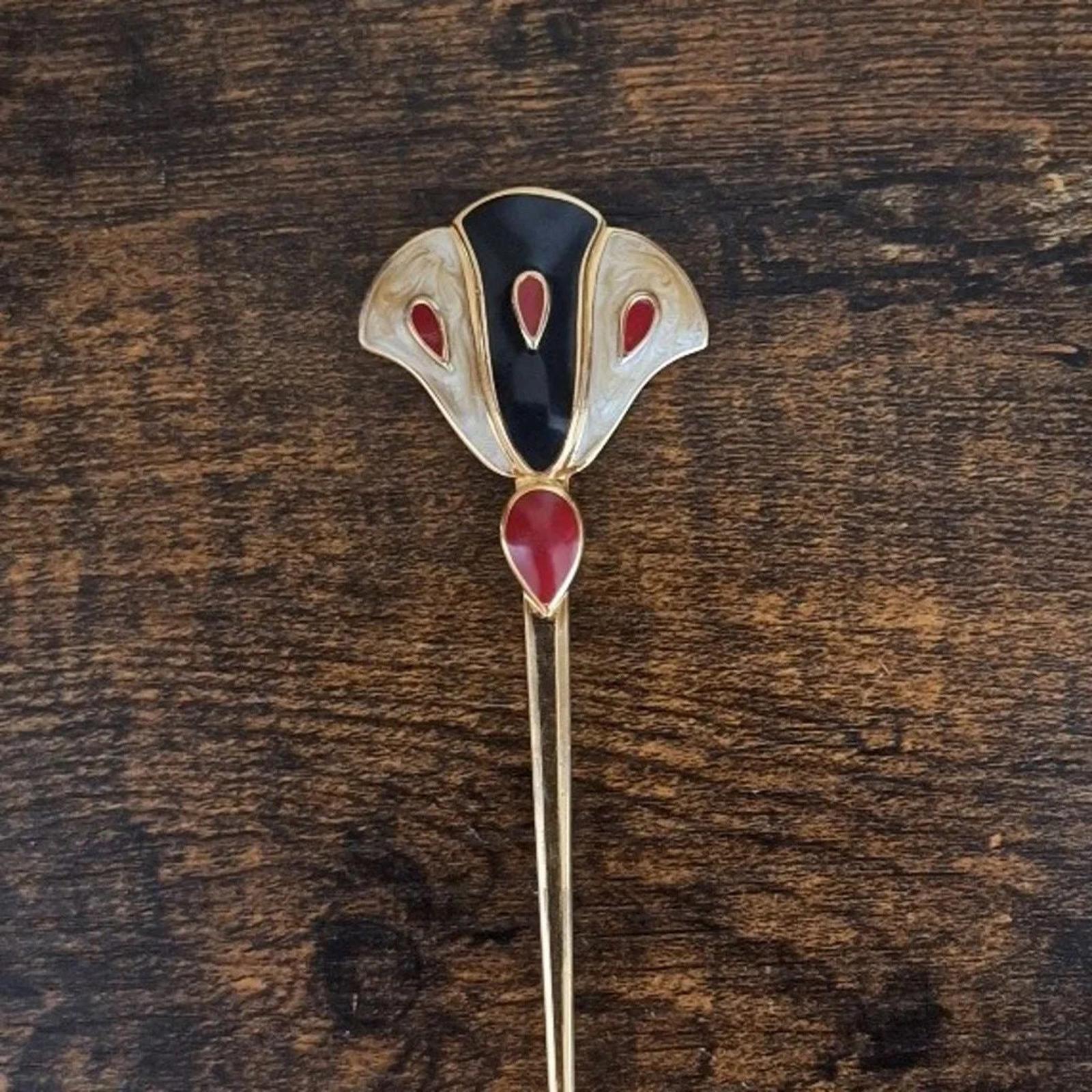 Gold-tone enamel flower pin brooch featuring a dark blue center and red drop-shaped petals
