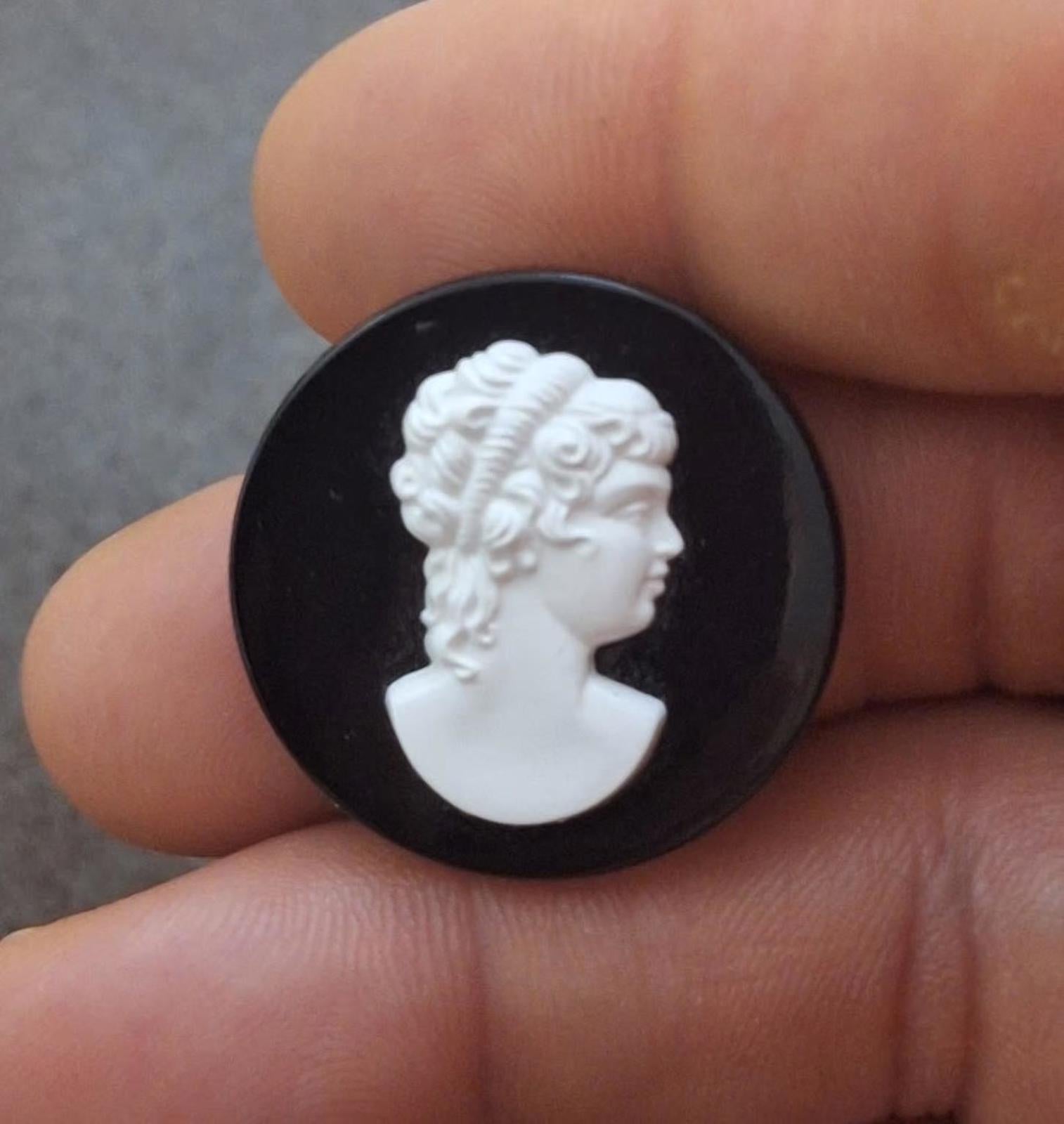 Black round cameo brooch with close-up white woman's head relief portrait
