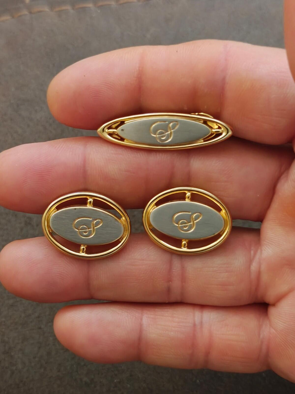 Oval blue enamel cufflinks with monogram initial, gold-tone bezels, shown in hand