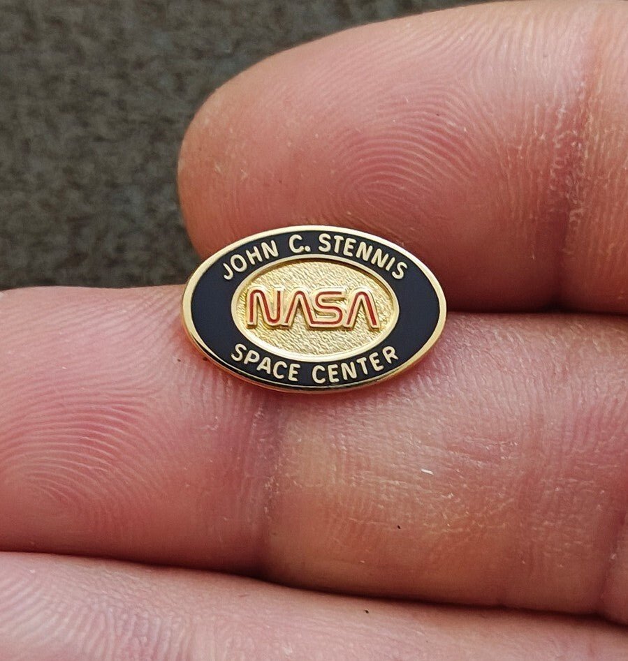 1980/90s NASA John C. Stennis Space Center Gold Tone Red & Black Enamel Pin. - Trinketmania-LV