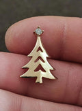 Gold-tone Christmas tree charm with clear rhinestone topper on metal bail