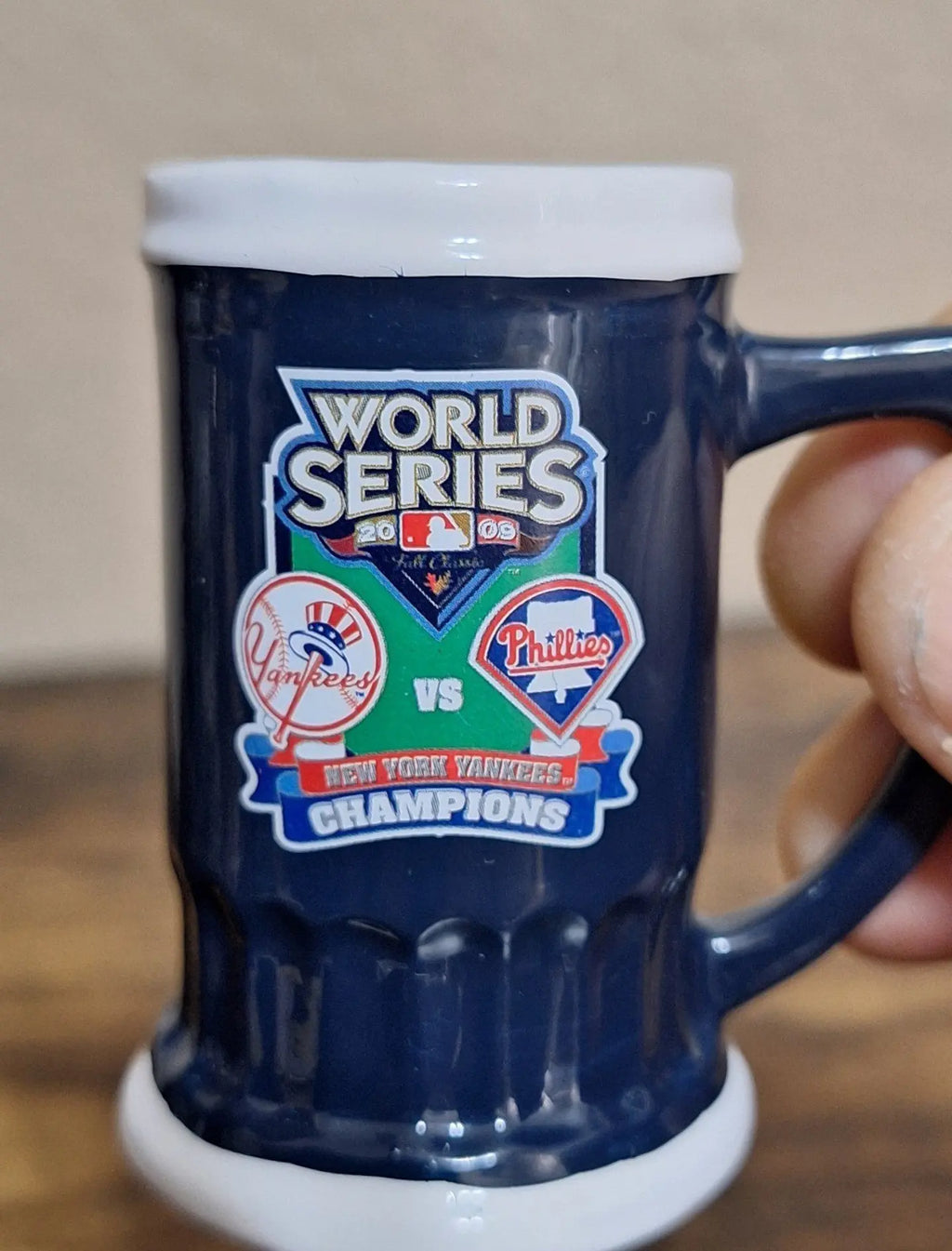 Dark blue miniature decorative mug with white rim and Yankees vs Phillies World Series logo