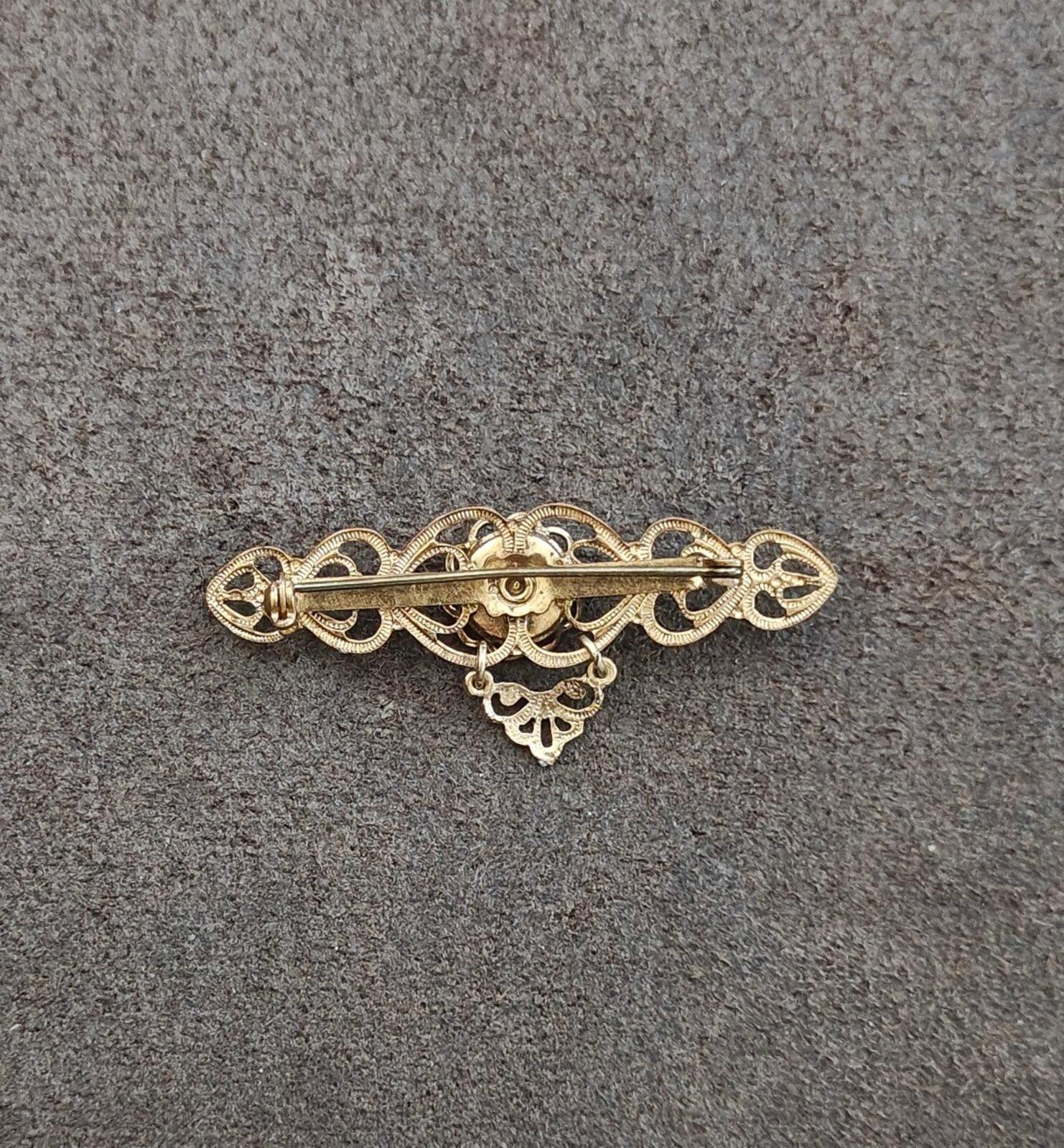 Gold-tone heart brooch pin with openwork back detailing and no visible stones
