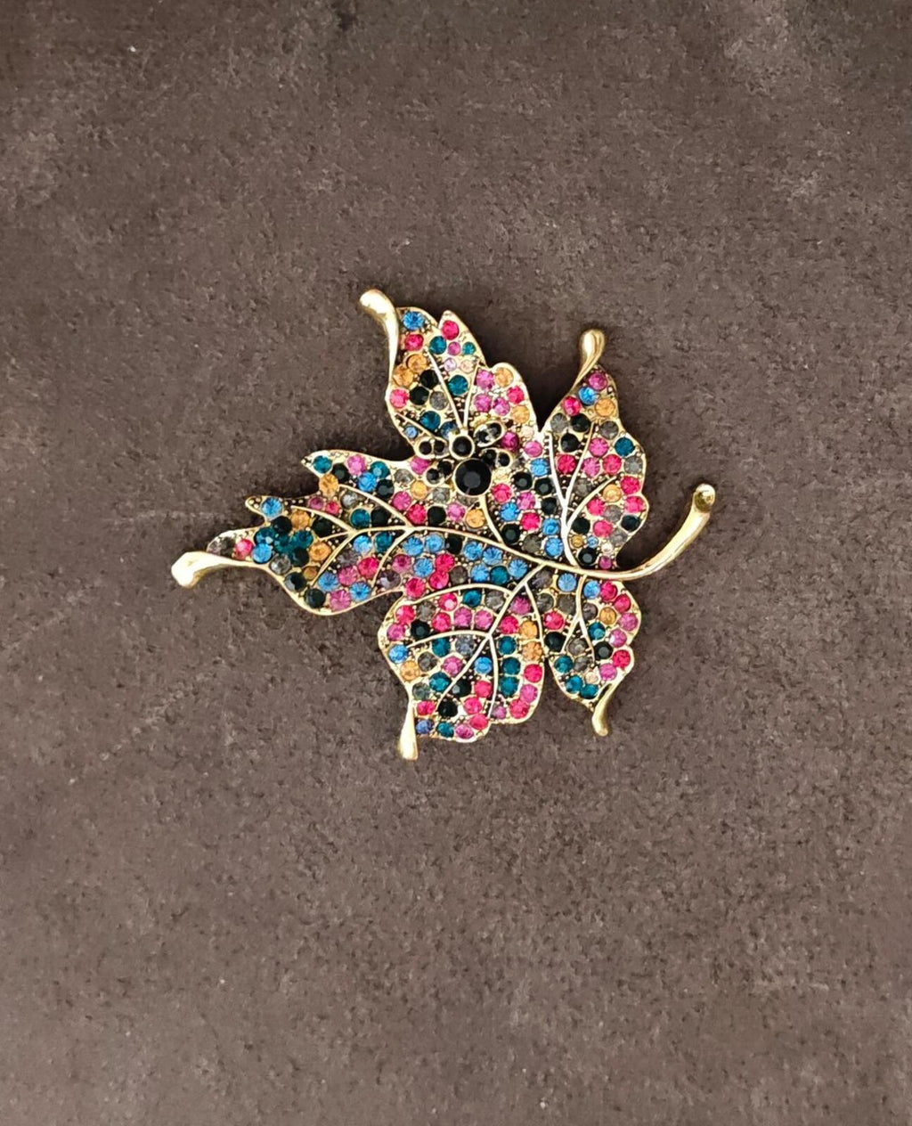 Gold tone maple leaf brooch, multicolor rhinestone leaf design with black center
