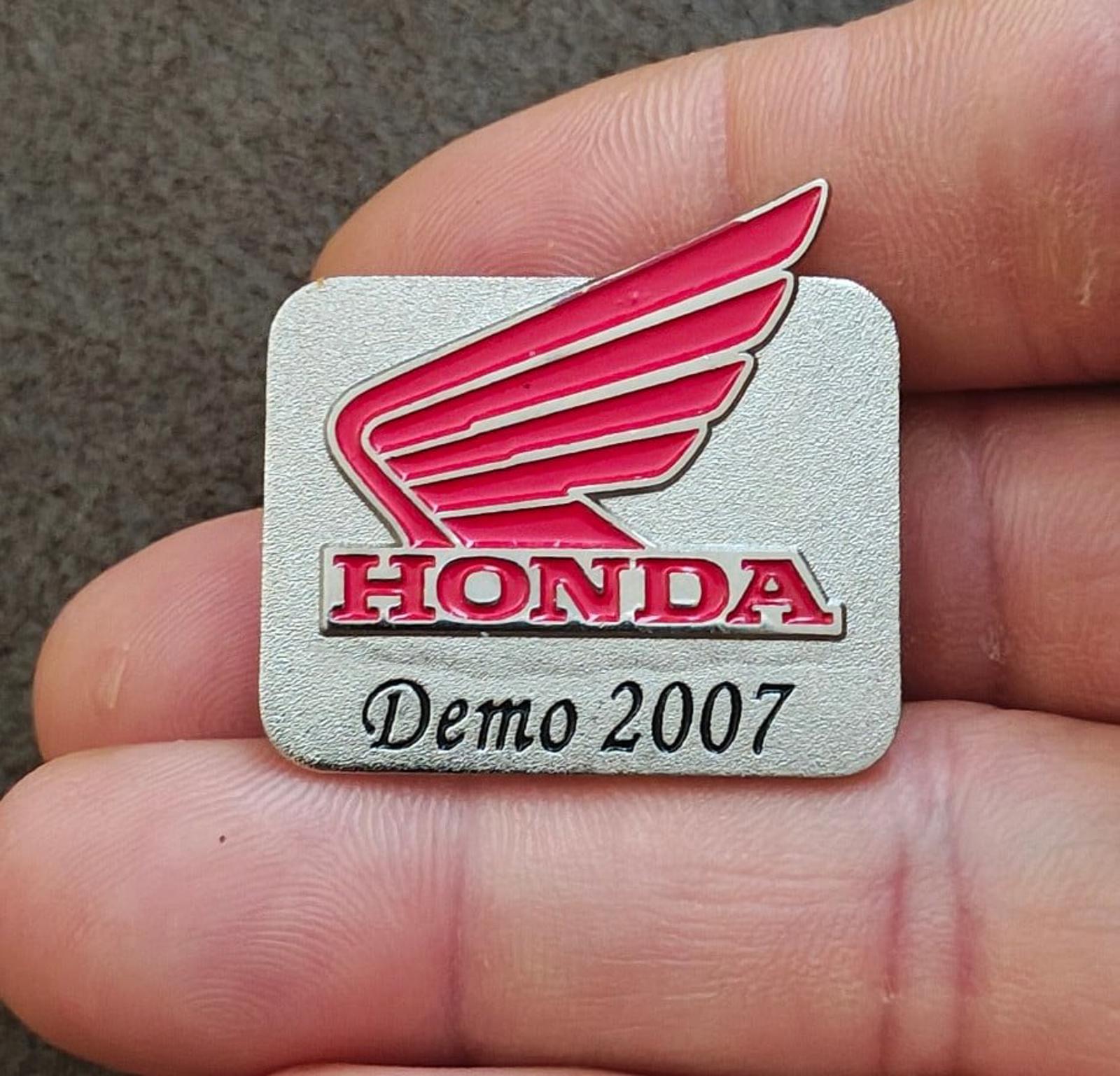 Silver-tone Honda Demo 2007 enamel pin with red wing logo and HONDA lettering