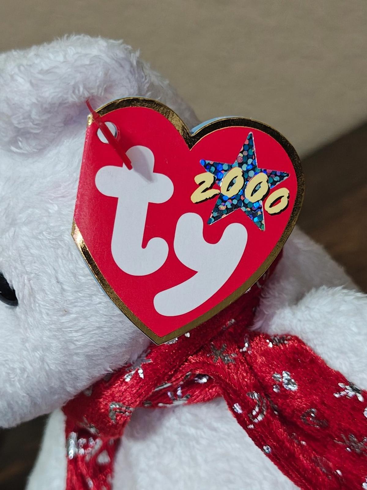 White bear plush with red holiday scarf; close-up of heart-shaped Ty tag