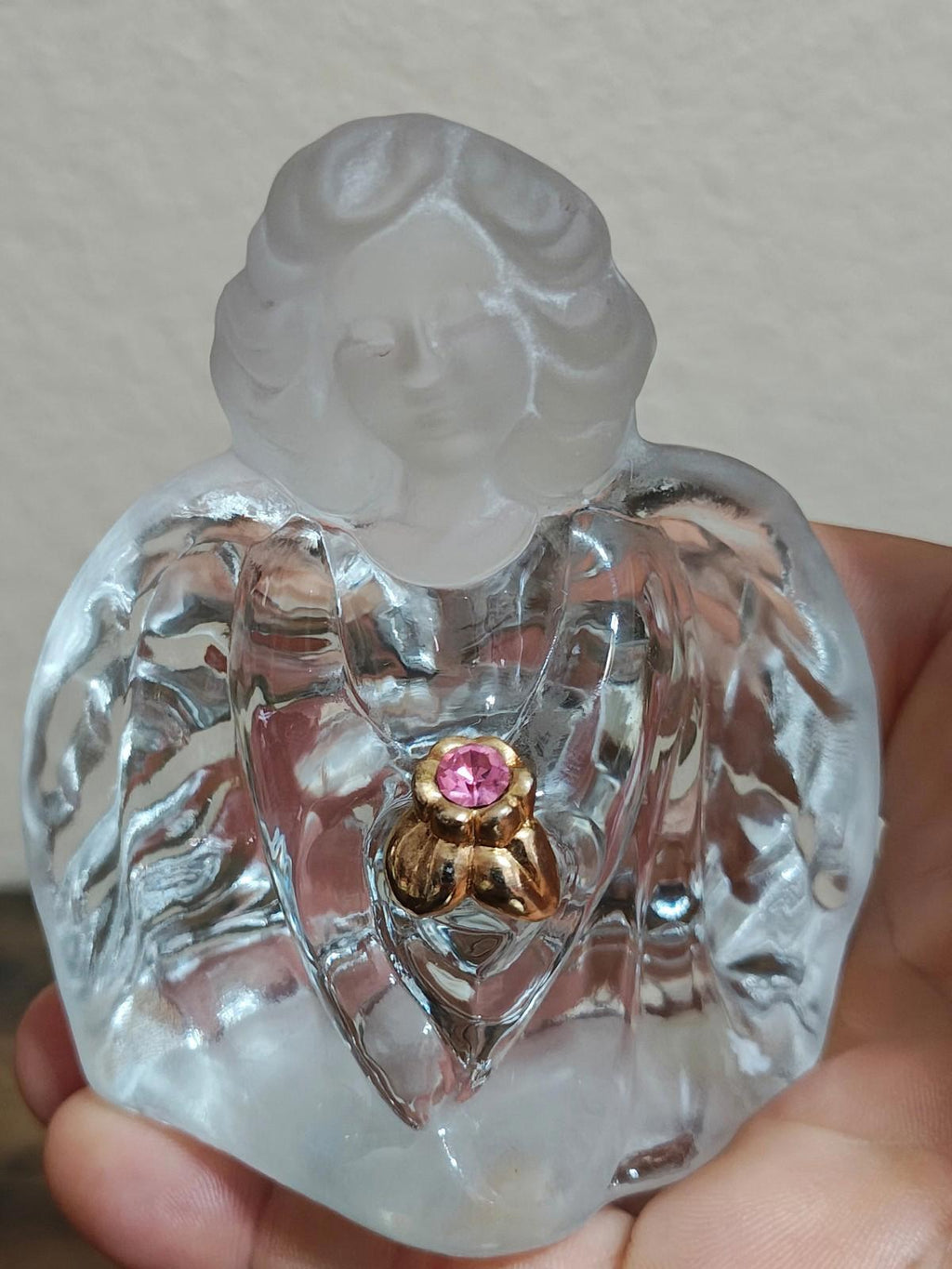Clear glass guardian angel figurine, front view, pink gemstone heart on gold-tone