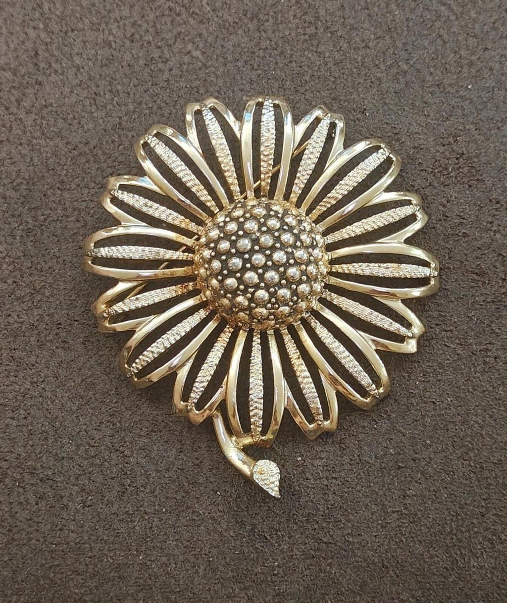 Gold tone sunflower brooch with ridged petal rays and bead-like round center detail