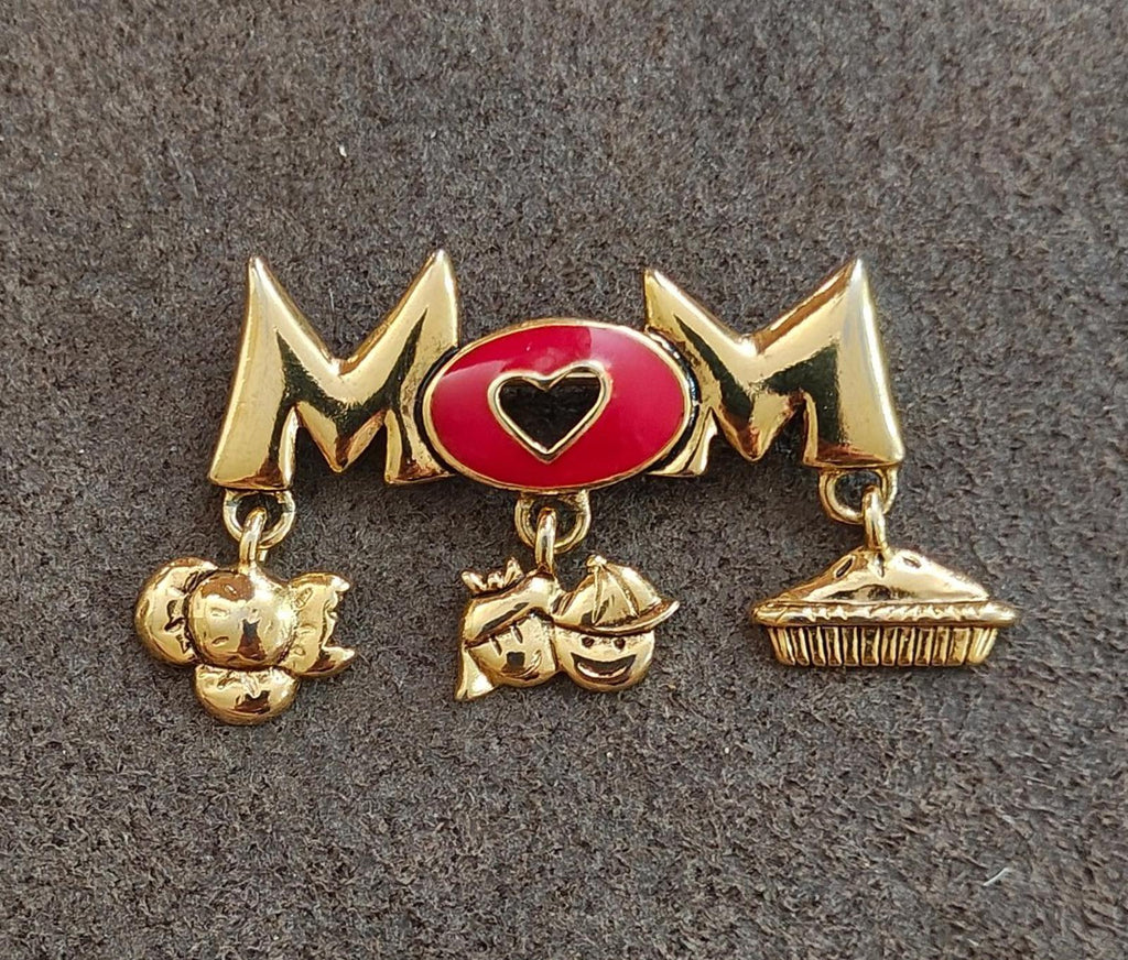 Gold-tone MOM brooch pin with red heart enamel center and three gold dangling charms