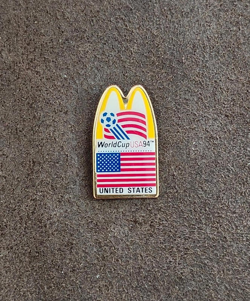 Gold-tone lapel pin with McDonald's arch and WorldCup USA '94 wording