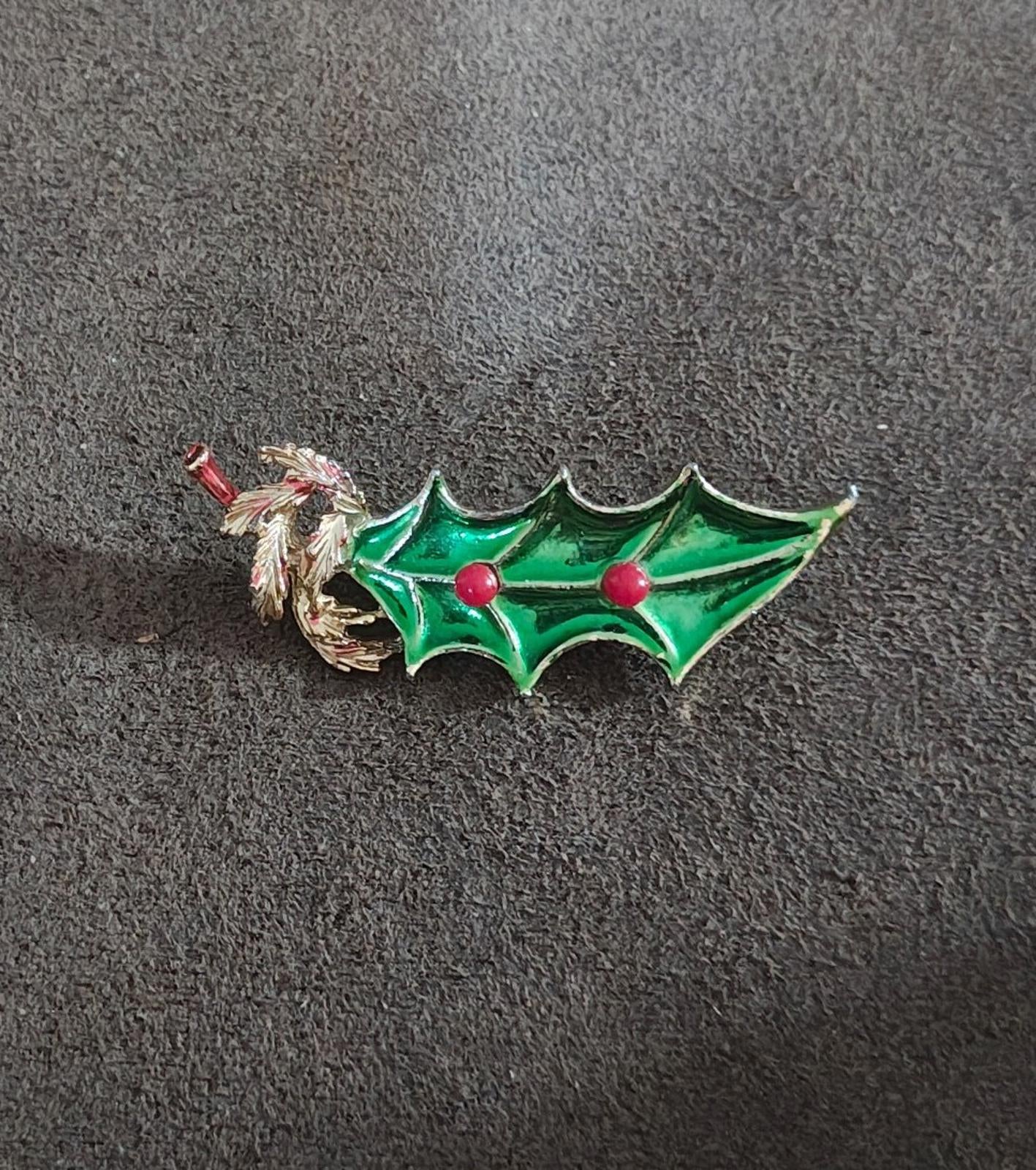 Holly Christmas brooch pin in green enamel with gold tone frame and red berries.