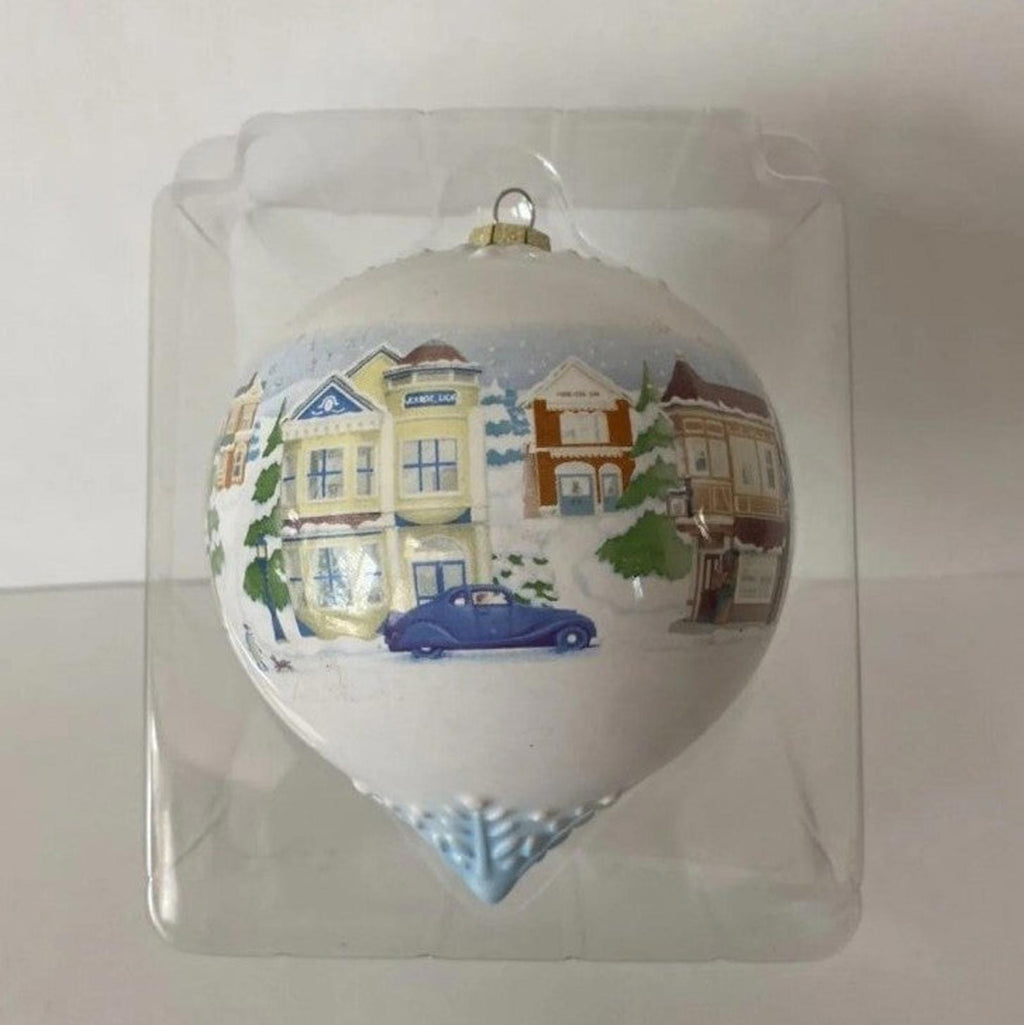Hallmark Keepsake teardrop ornament showing Main Street houses and a blue car scene