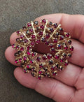 Gold-tone rhinestone brooch pin with maroon and dark red oval stones