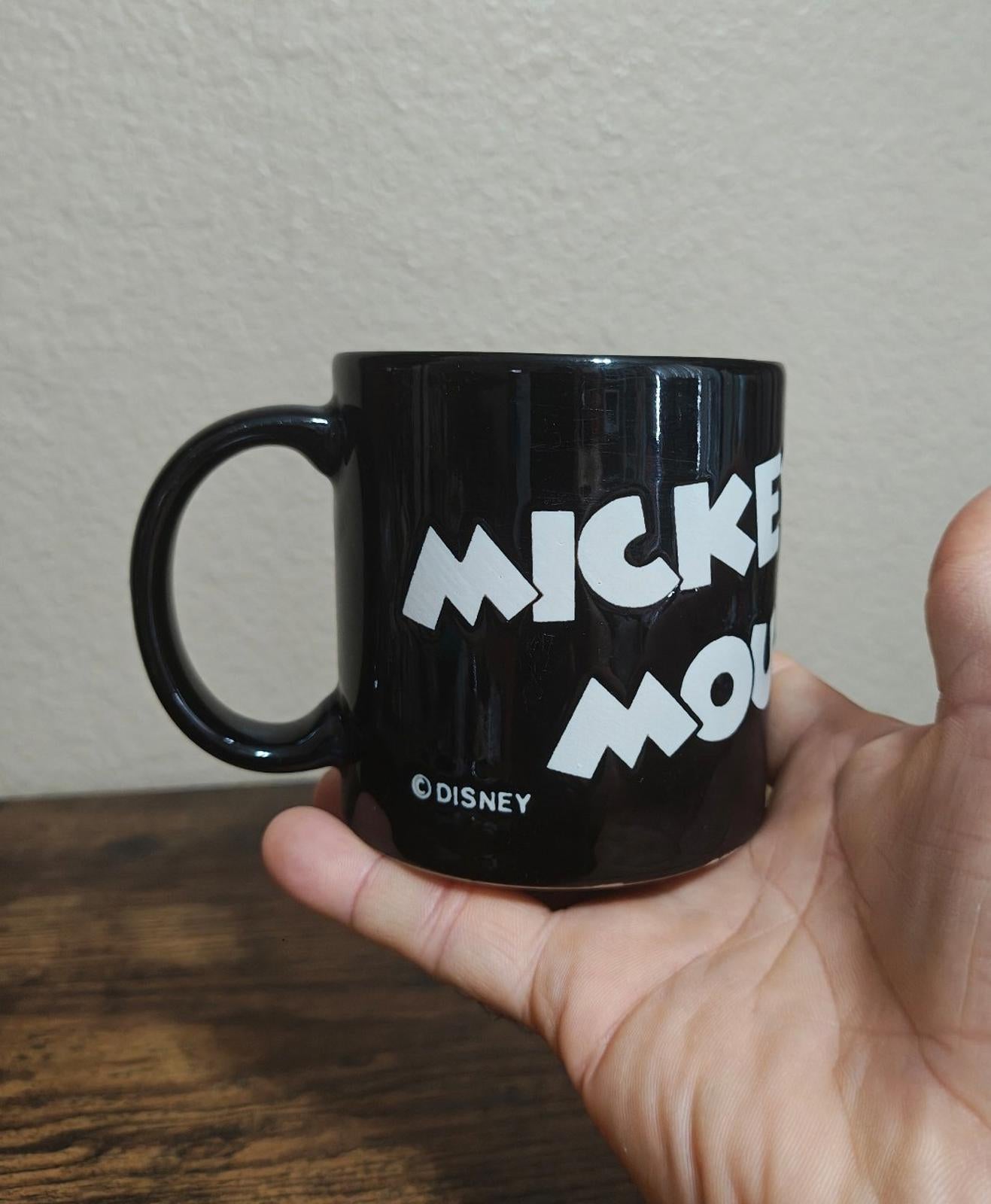 Black mug with white “MICKEY” and “MOUSE” text graphic and handle