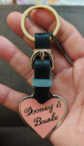 Dooney & Bourke heart keychain with black leather strap, light blue accent, gold ring