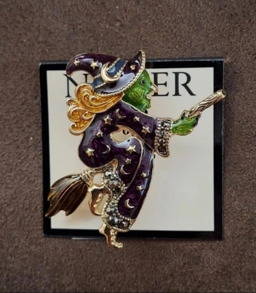 Gold-tone witch enamel pin brooch on display card, dark purple with green highlights