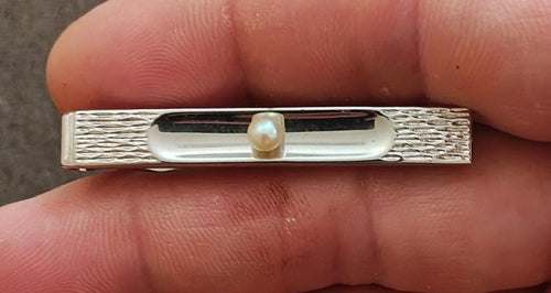 Silver-tone bar pin with centered pearl and textured side panels