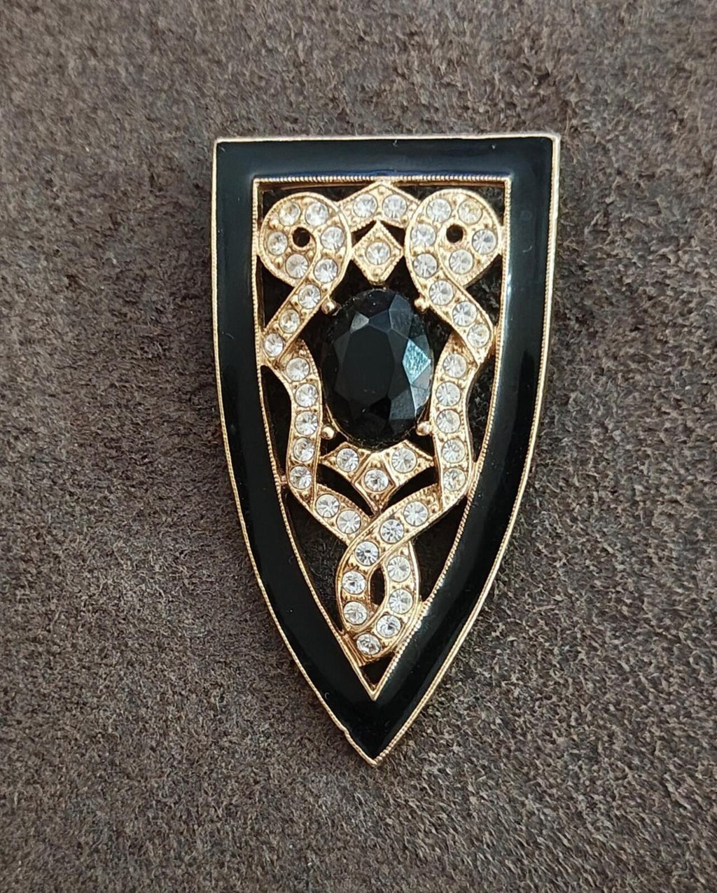 Front view shield brooch in gold tone with black center stone and clear rhinestone detailing