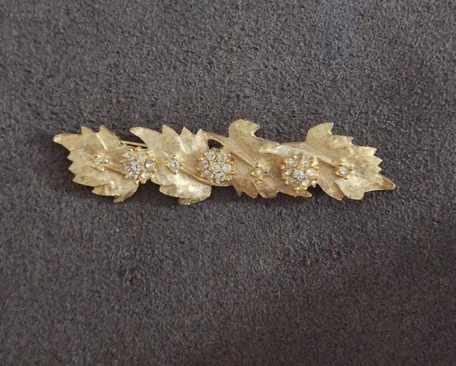 Gold tone leaf rhinestone brooch pin with five oval sparkle settings