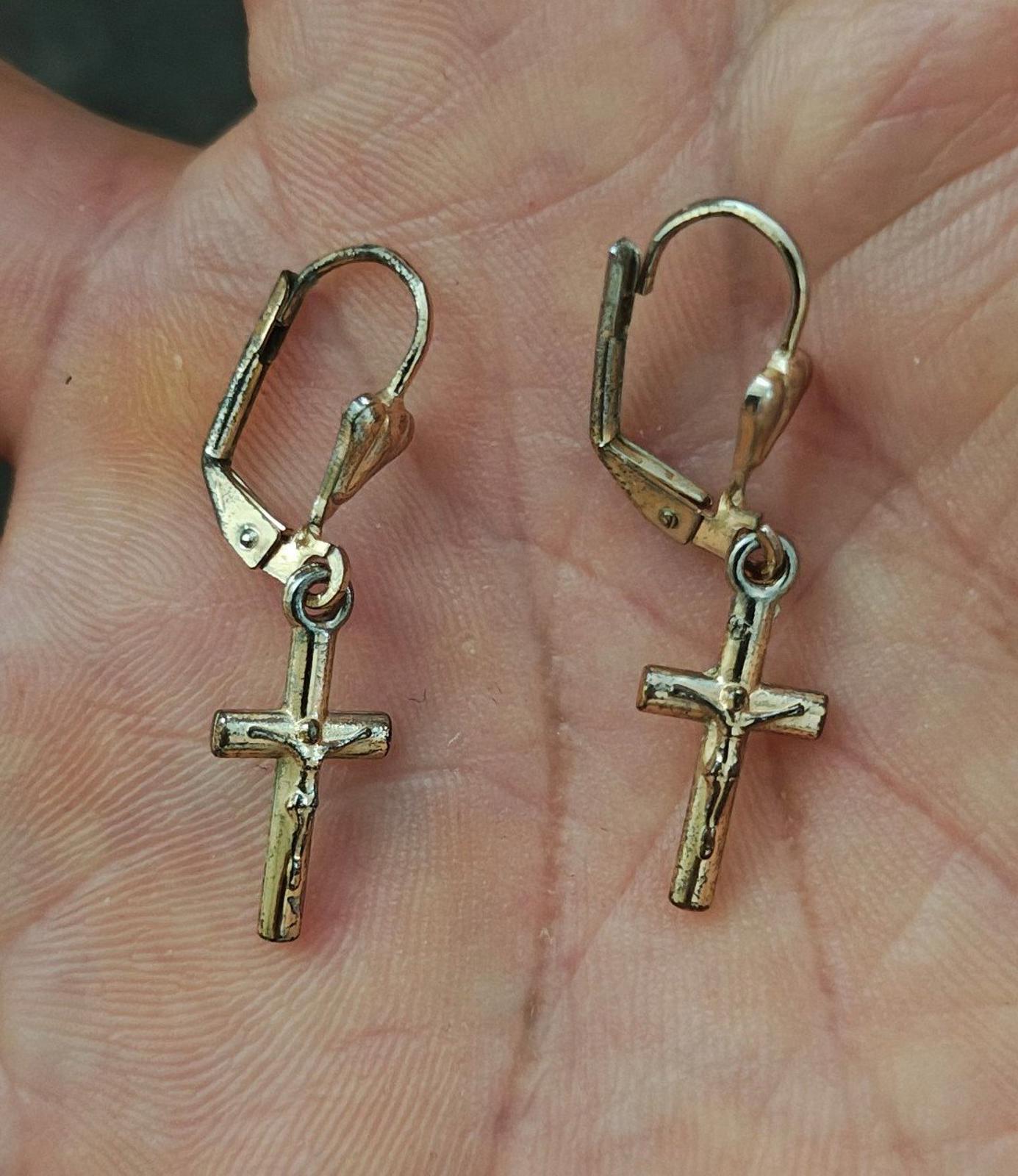 Gold-tone cross dangle earrings with heart top charm and hinged hook backs.