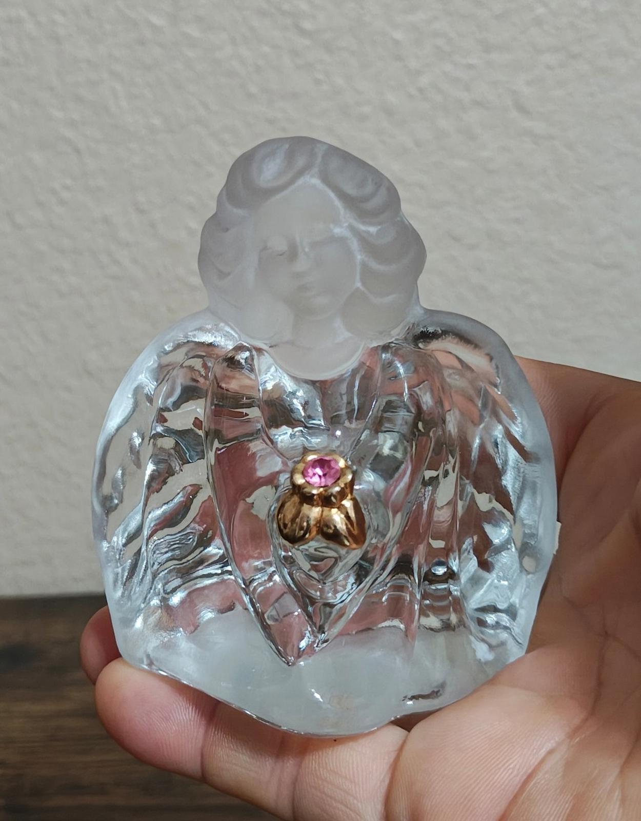 Clear glass guardian angel figurine with pink gemstone heart in gold-tone setting