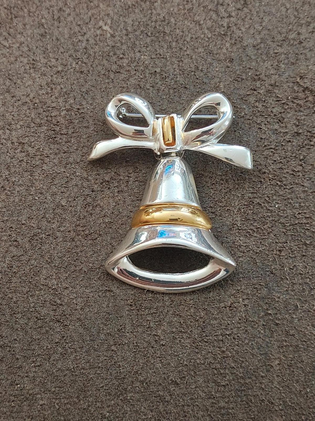 Two-tone Christmas bell bow brooch front view, silver and gold-tone metallic finish