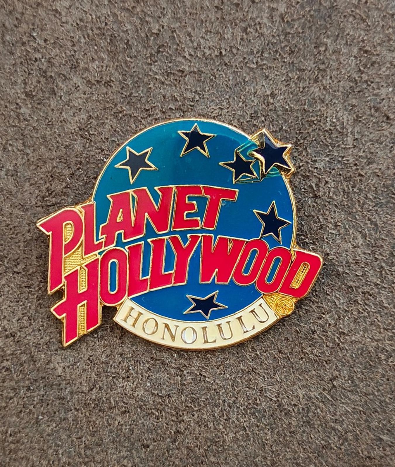 Planet Hollywood Honolulu enamel lapel pin with star accents, blue background and red lettering