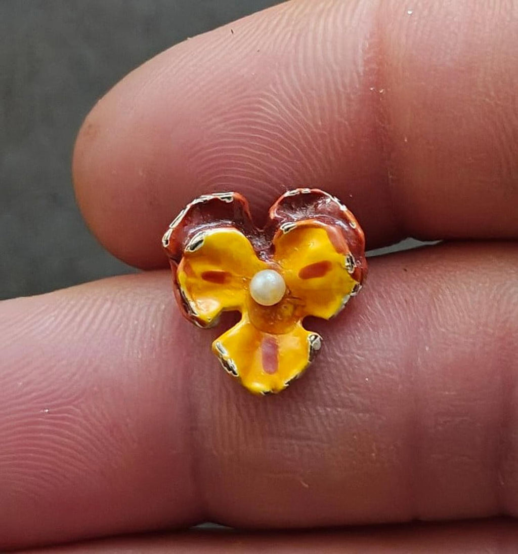 Small pansy enamel brooch with yellow-orange petals, maroon edges, and faux pearl in middle